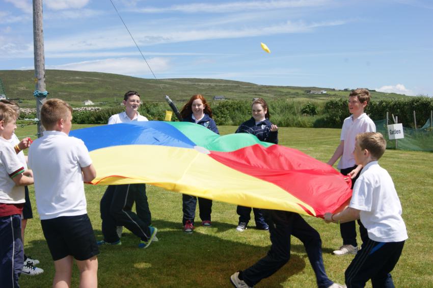 children playing with a flag at glenderry national school